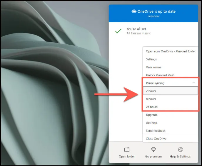 OneDrive system tray icon right-click context menu showing you Pause syncing option.